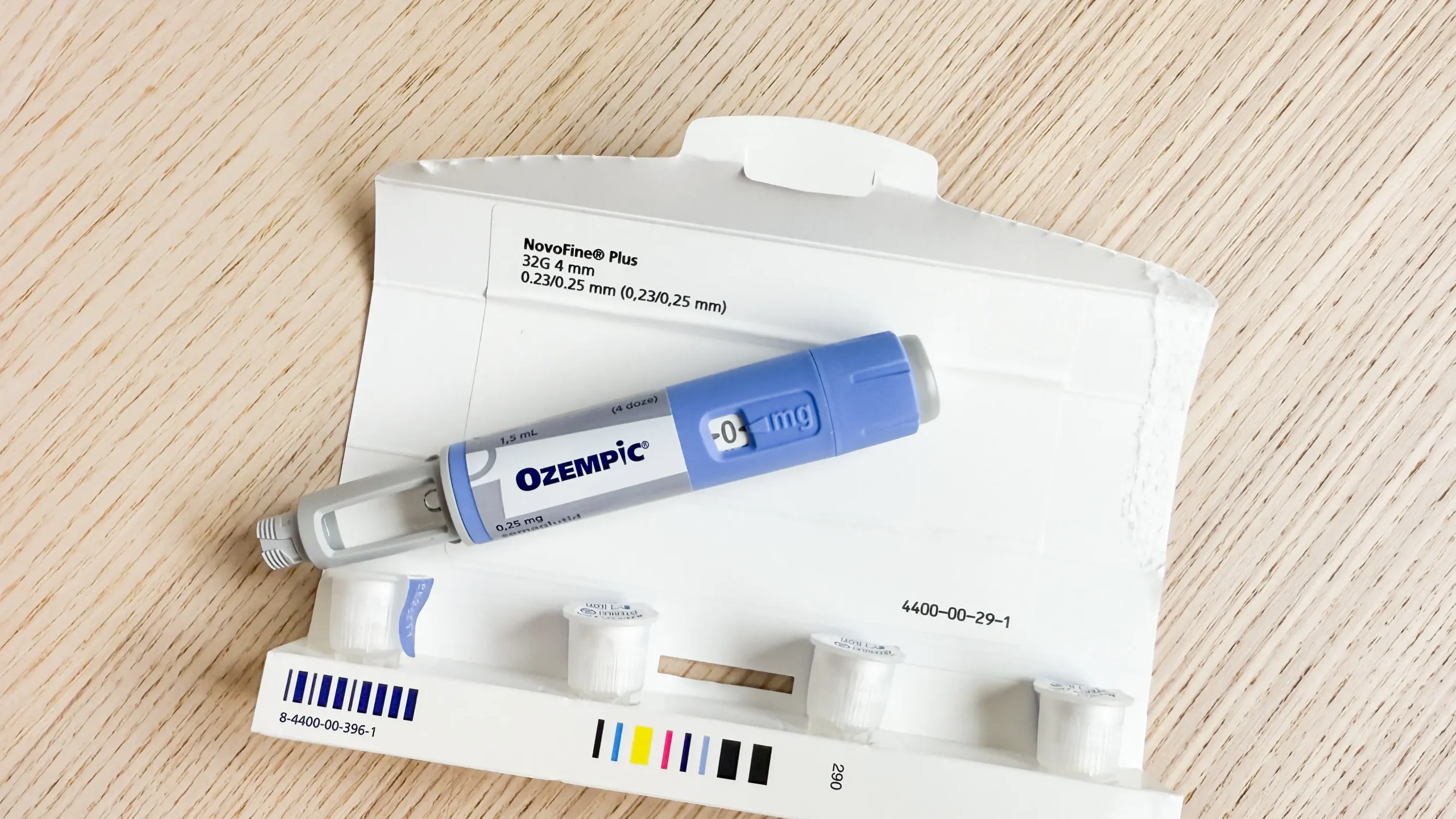 Close-up of Ozempic injection pen and packaging on wooden surface